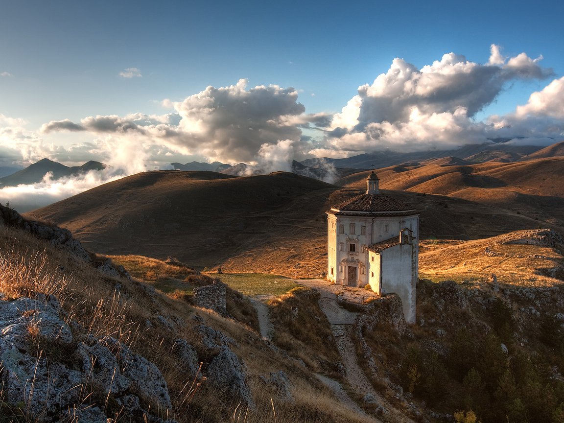 Обои небо, облака, горы, холмы, природа, камни, кусты, церковь, the sky, clouds, mountains, hills, nature, stones, the bushes, church разрешение 2560x1600 Загрузить