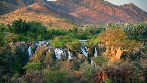 Обои деревья, река, горы, камни, кусты, водопад, angola, oncocua, trees, river, mountains, stones, the bushes, waterfall разрешение 2560x1755 Загрузить