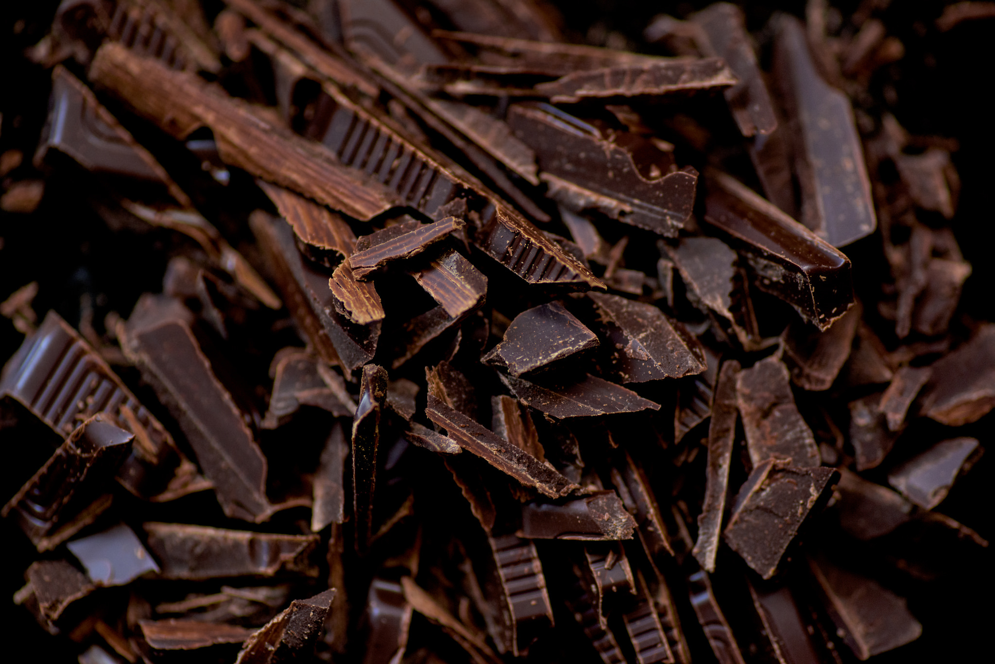 Дробленый шоколад. Темный шоколад. Кусок шоколада. Ломаный шоколад. Шоколад фон.