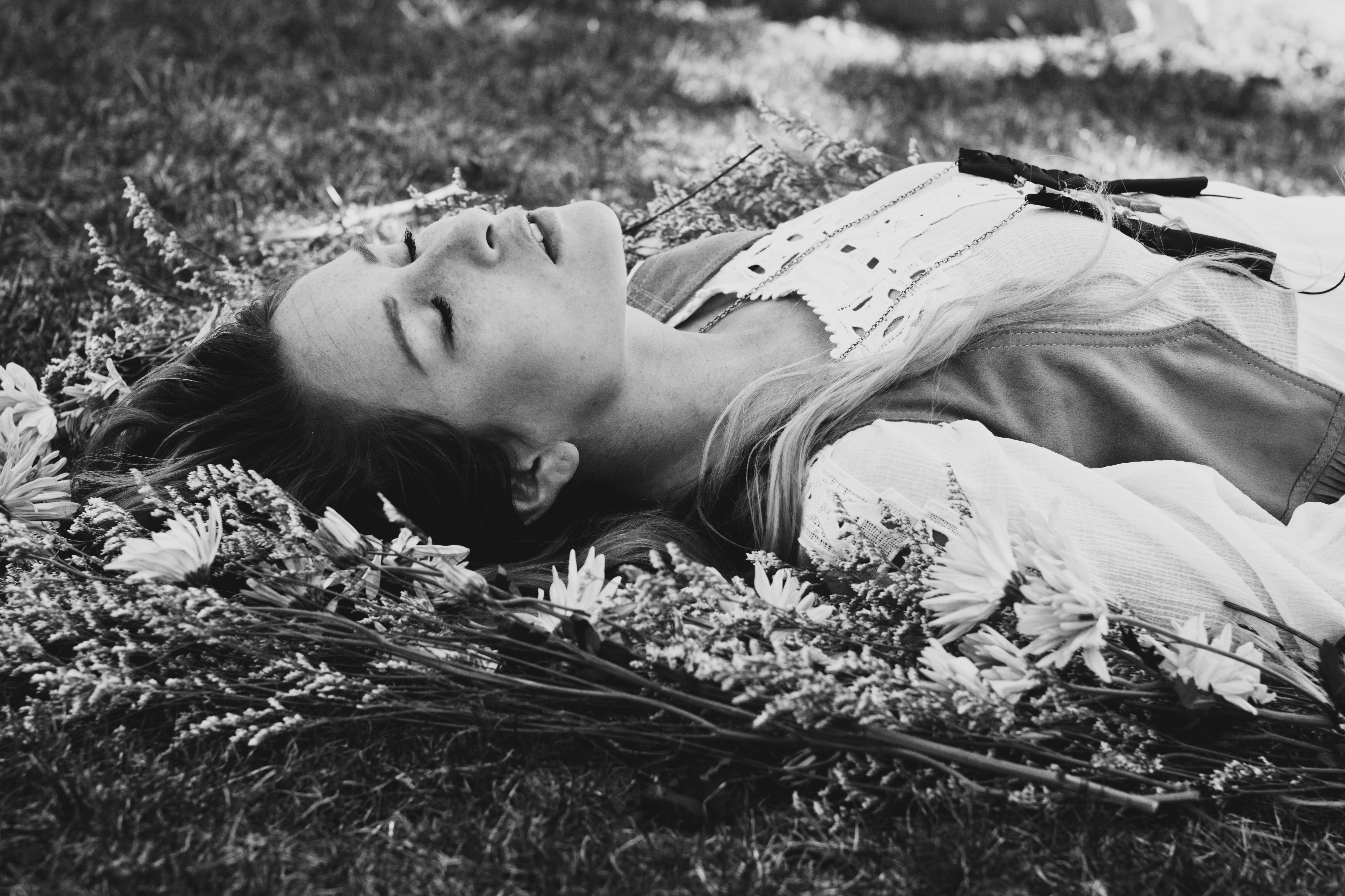 Саша устала. Девушка лежит на траве. Девушка лежит черно белое.